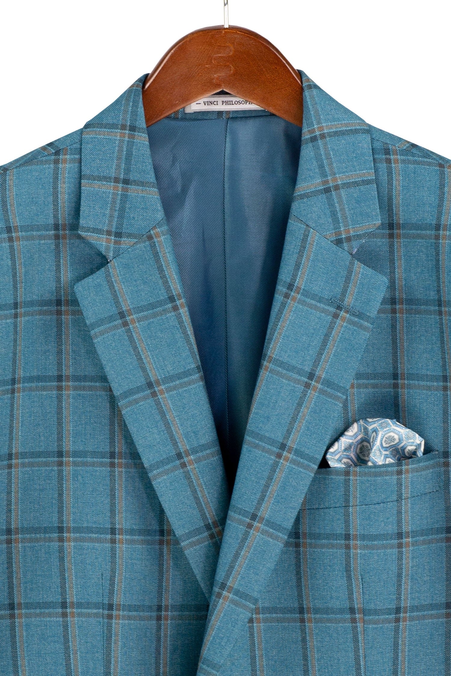 A blue plaid blazer jacket with a patterned pocket square, hanging on a wooden hanger against a white background.