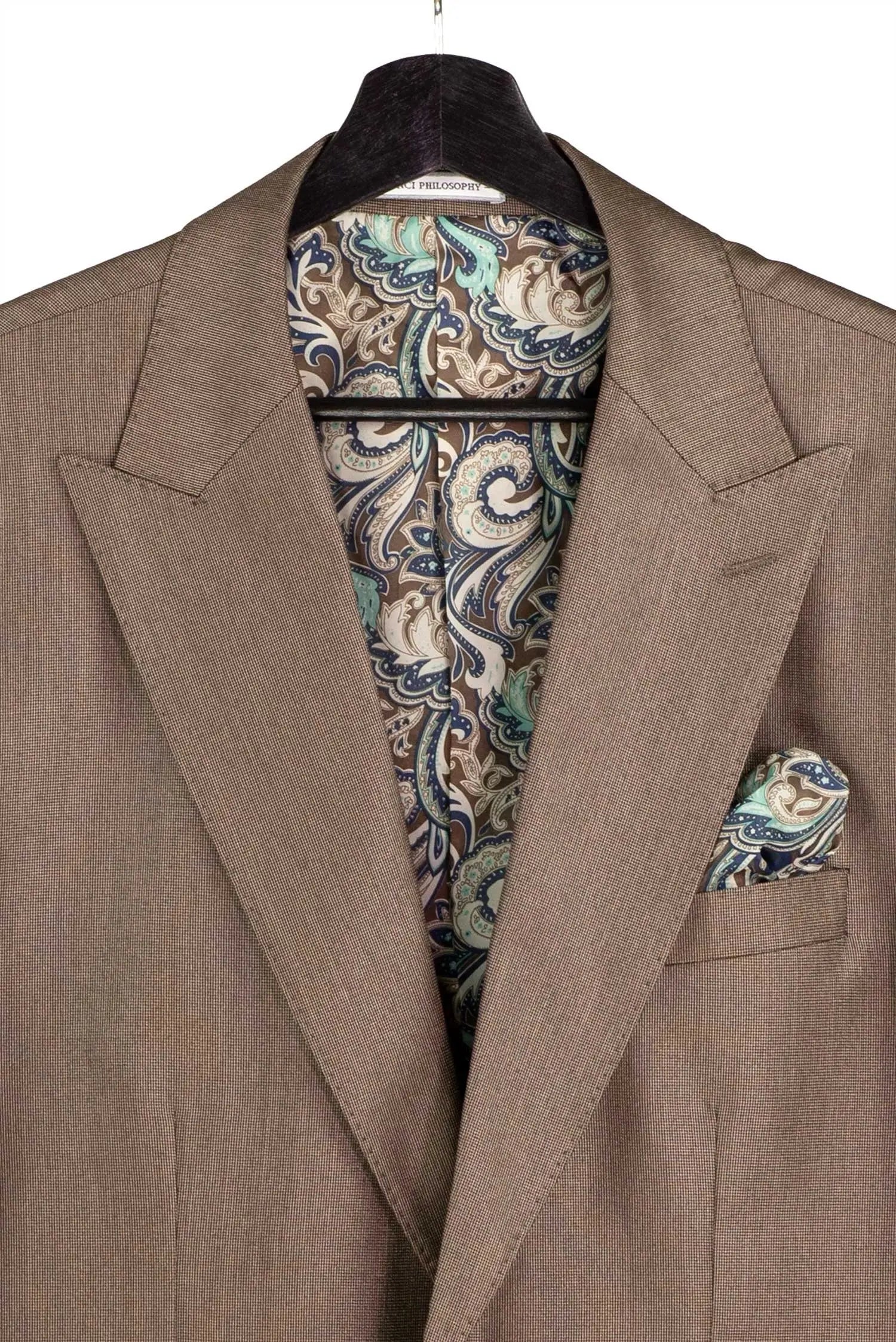 A close-up of a taupe brown suit jacket with a matching paisley pocket square, displayed on a black hanger against a white background.