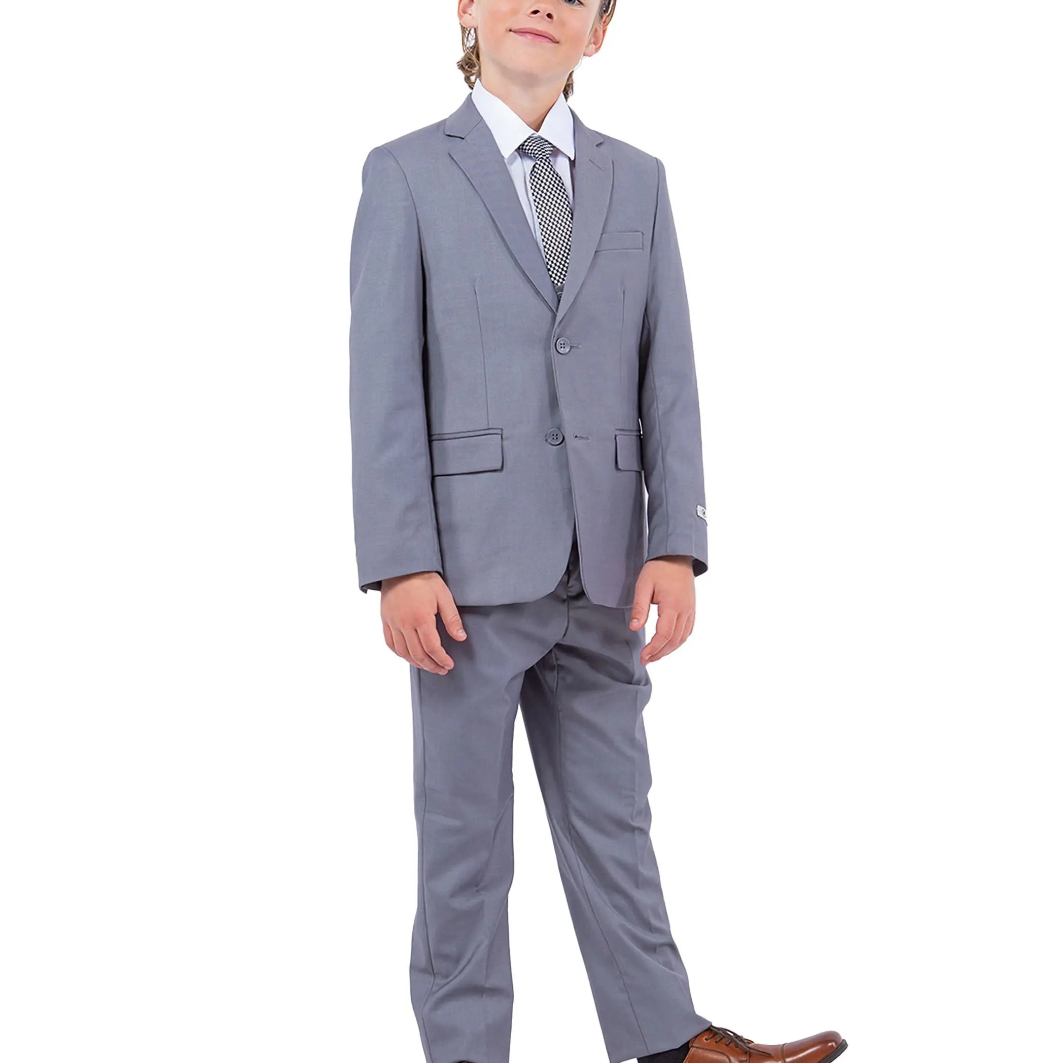 Child wearing a gray suit with a white shirt and brown shoes on a white background