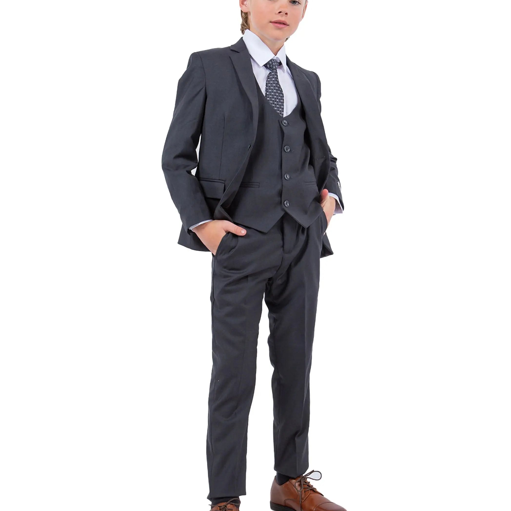 Child wearing a gray suit with a white shirt and brown shoes on a white background