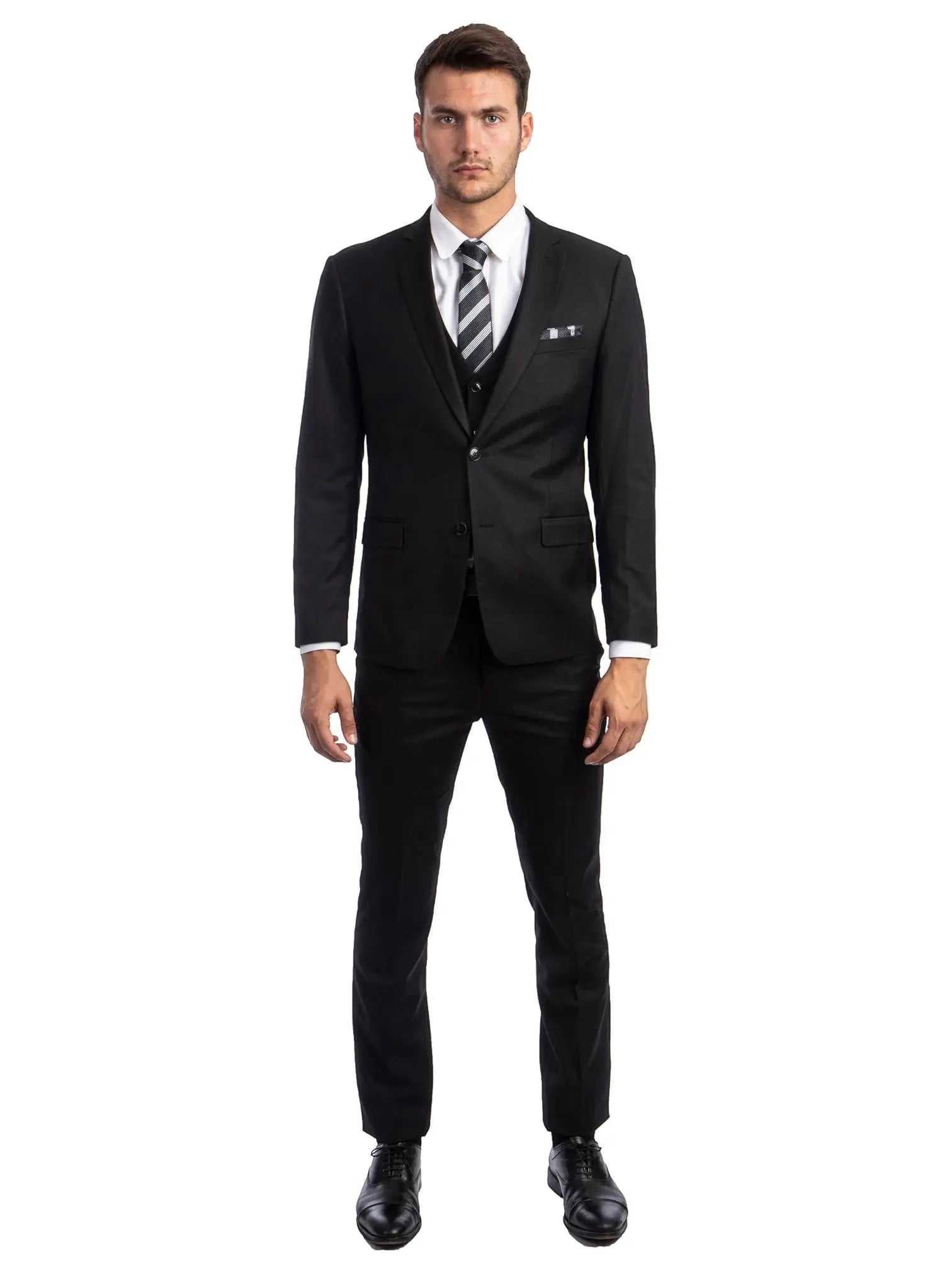 A man wearing a M & R Clothing black skinny-fit 3-piece suit with a white shirt and striped tie against a white background