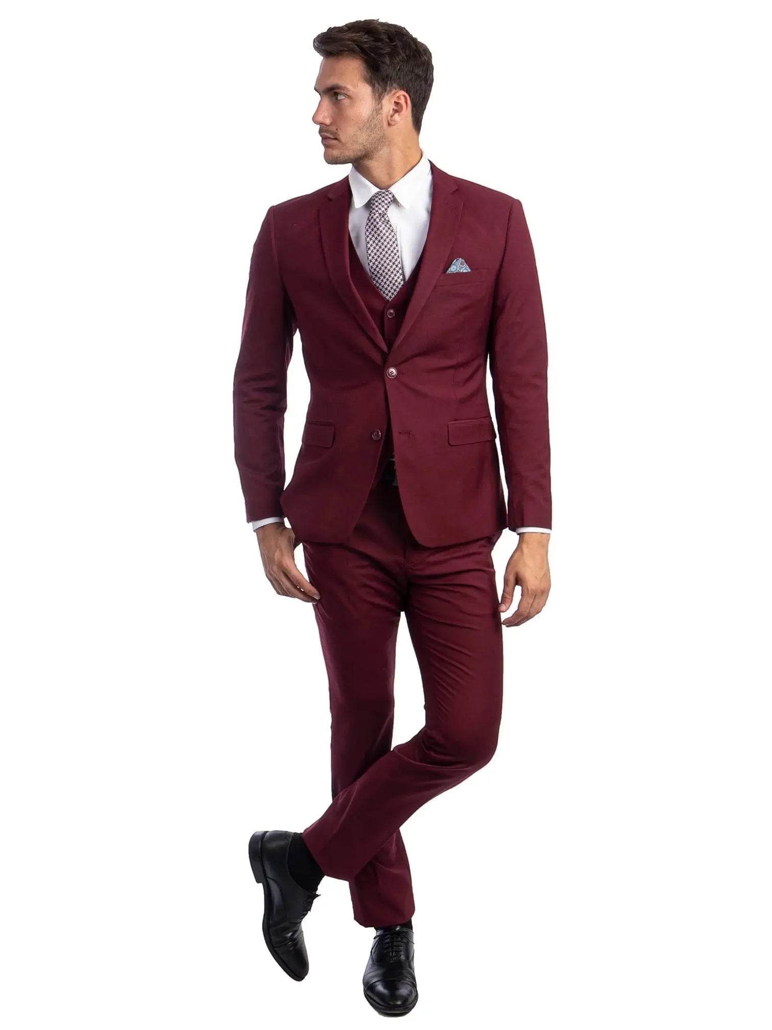 Model wearing a M & R Clothing burgundy skinny-fit 3-piece suit with a white shirt, patterned tie, and black shoes.