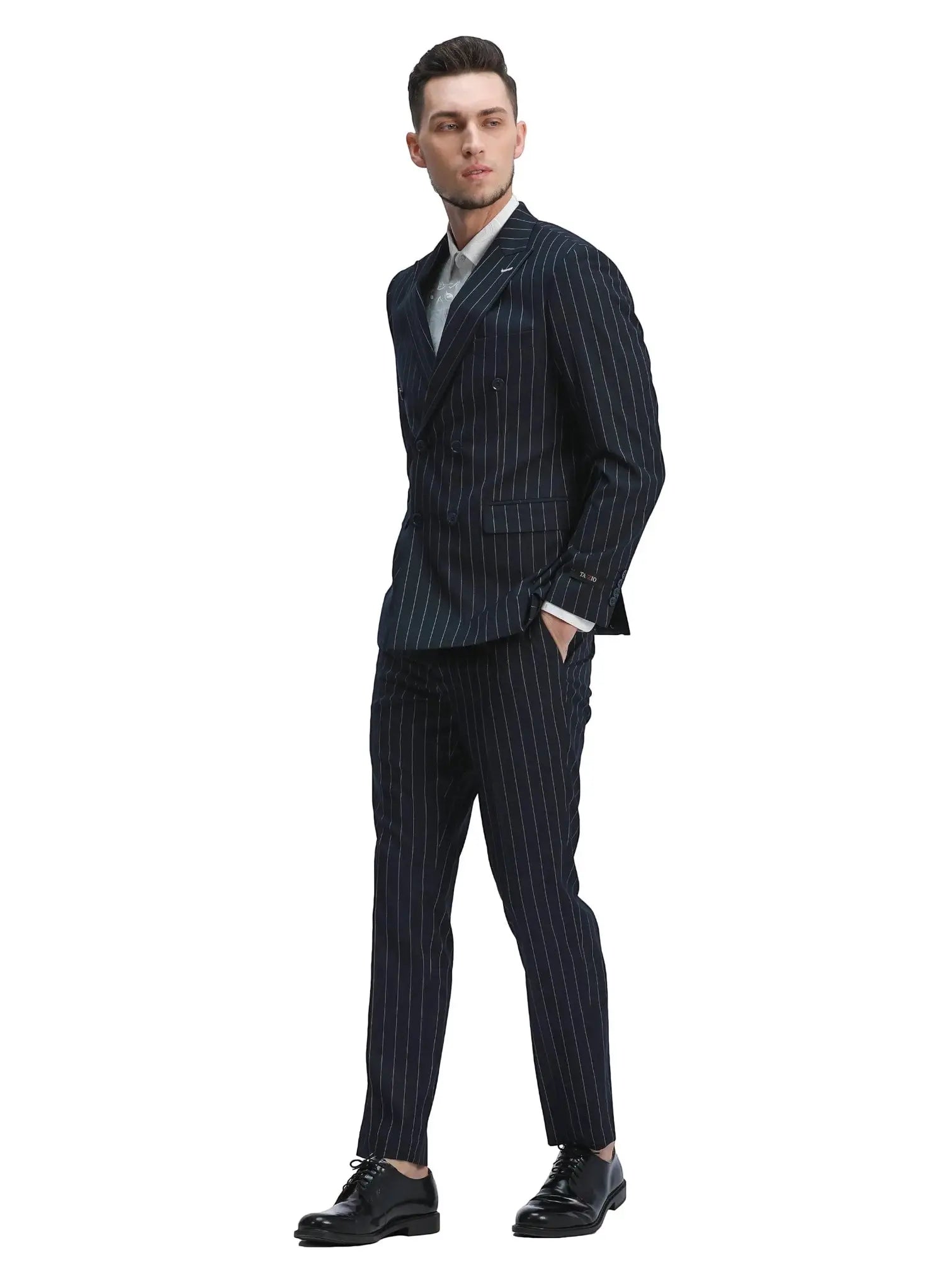 Model wearing a navy M & R Clothing slim fit double-breasted pinstripe suit with peak lapels and flat front trousers.