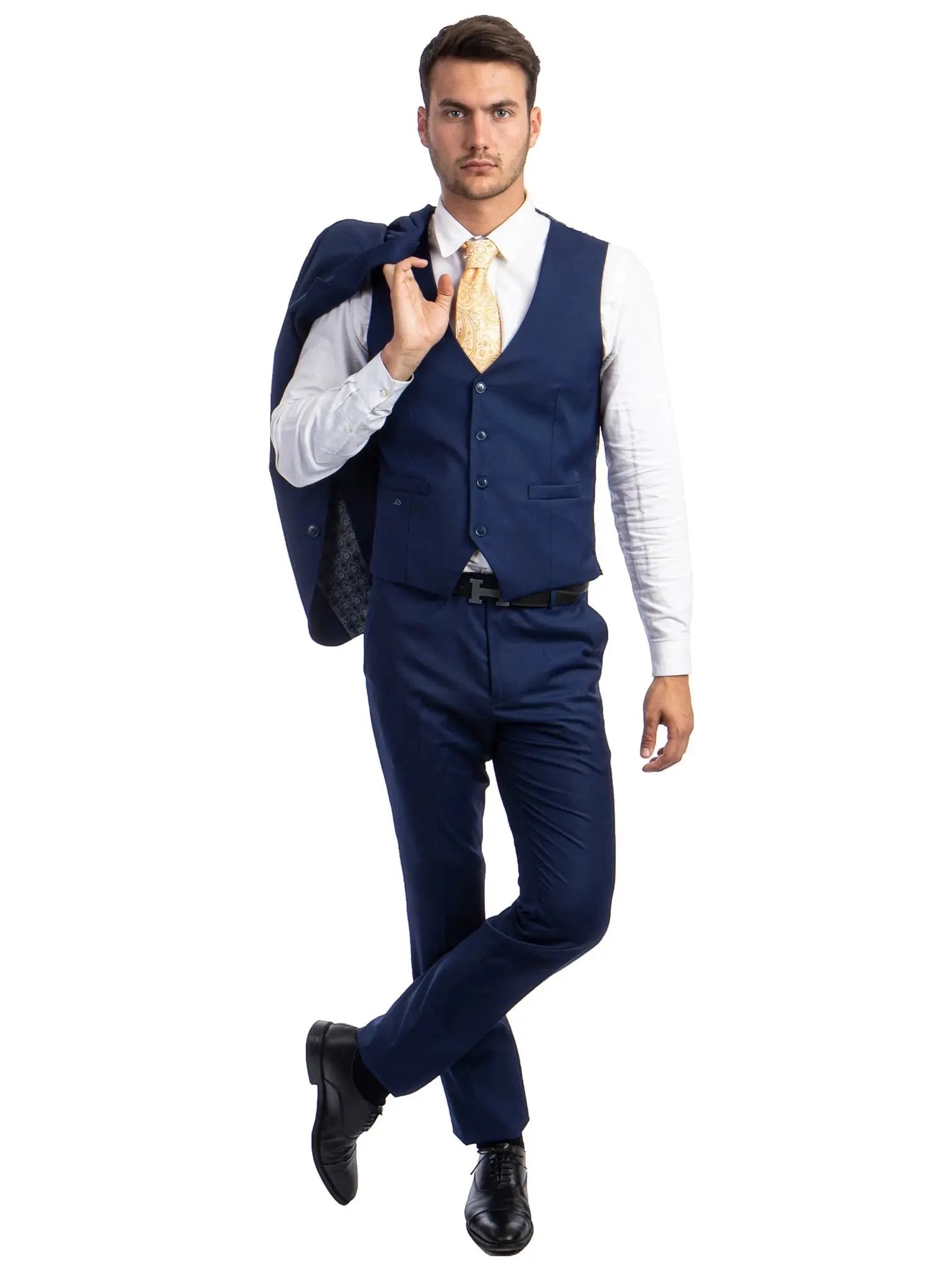 Model wearing a M & R Clothing navy blue skinny-fit 3-piece suit with a vest, white shirt, and patterned gold tie.