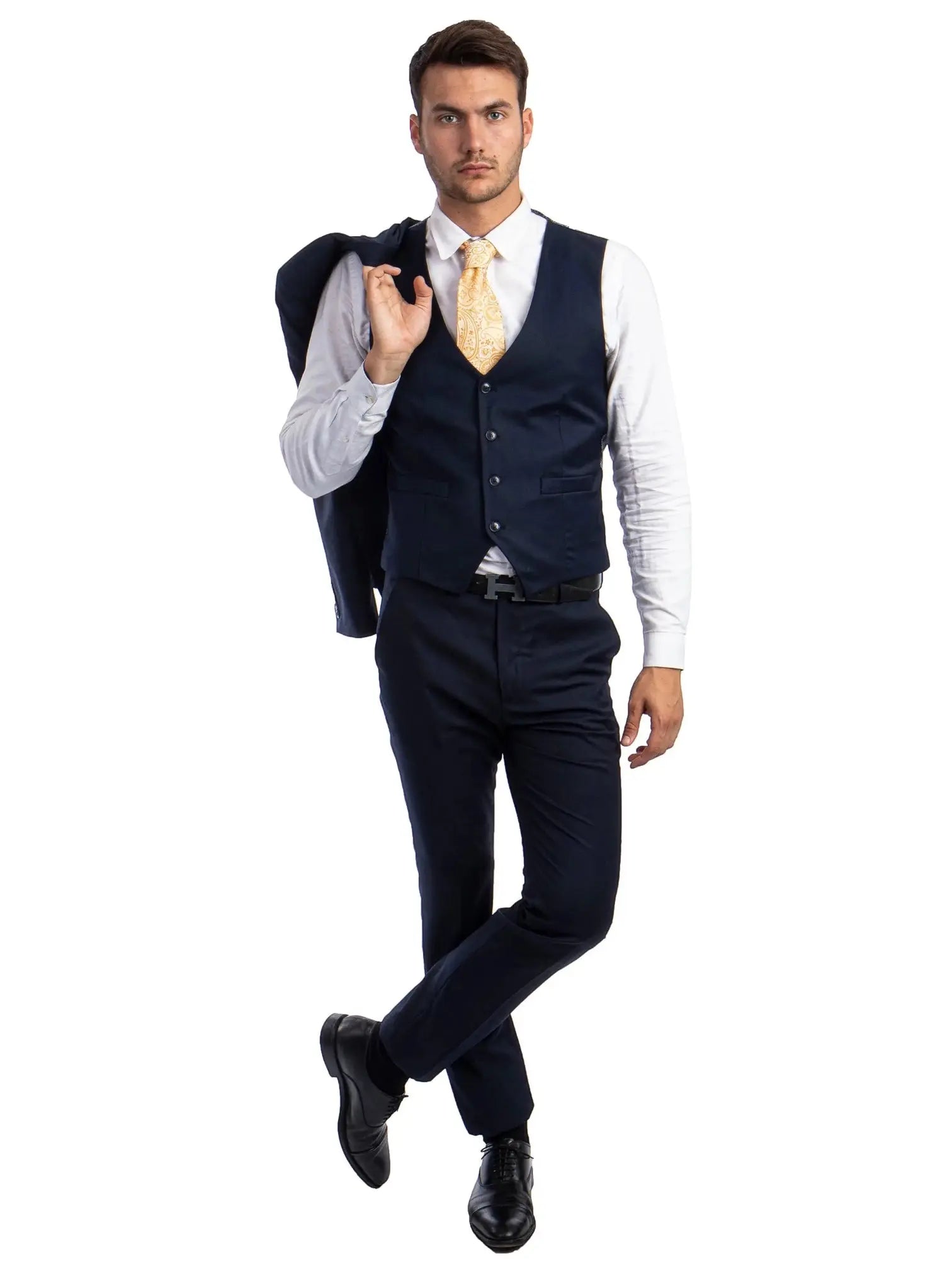 A man wearing a navy M & R Clothing skinny-fit 3-piece suit with a white shirt and patterned gold tie
