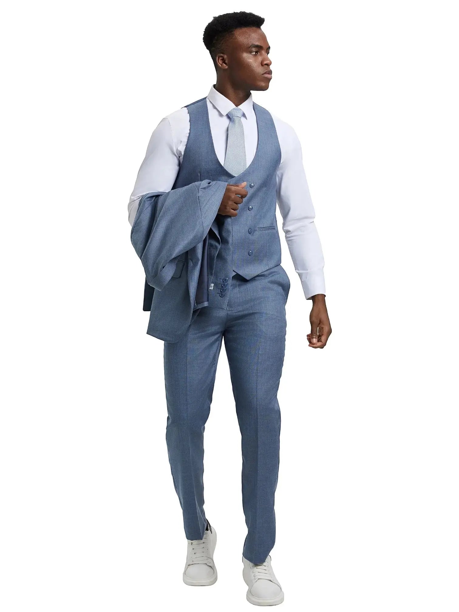Model wearing a blue M & R Clothing Stacy Adams sharkskin 3-piece suit with a vest and jacket draped over his arm.