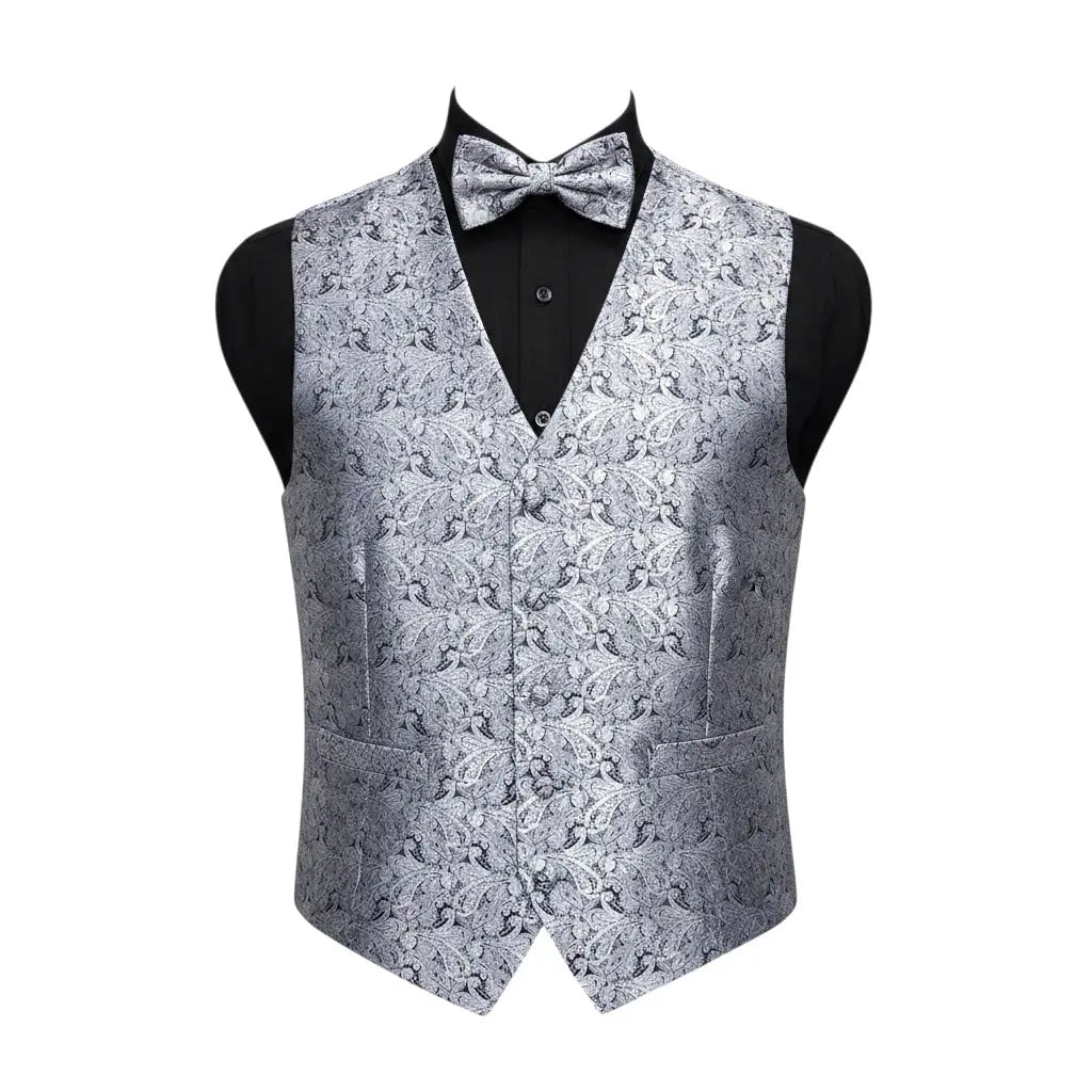 A men's formal vest with a matching bow tie, displayed on a black mannequin torso against a plain white background. The vest and bow tie feature an intricate silver and gray damask pattern, while the shirt underneath is solid black.