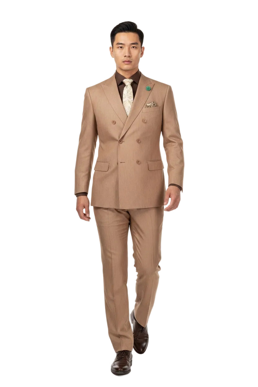 A man modeling a tan double-breasted suit with a brown shirt, beige patterned tie, and brown dress shoes against a plain white background.