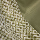 Close-up of fabric with geometric pattern and solid color swatch