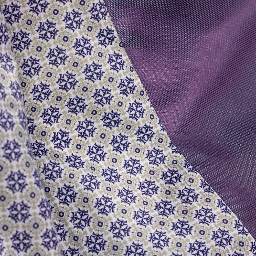 Close-up of fabric with a patterned design on one side and solid color on the other