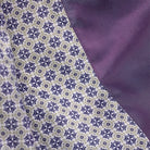Close-up of fabric with a patterned design on one side and solid color on the other