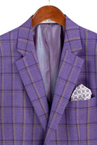 A purple plaid blazer jacket with a patterned pocket square, hanging on a wooden hanger against a white background.