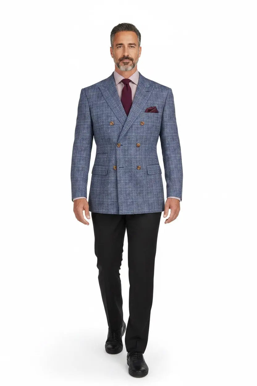 A man modeling a blue and gray double-breasted plaid suit jacket with gold buttons, paired with black trousers, a burgundy tie, and a matching pocket square, on a white background.