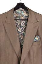 A close-up of a taupe brown suit jacket with a matching paisley pocket square, displayed on a black hanger against a white background.