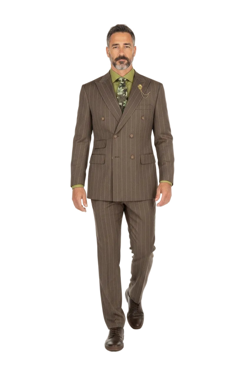 A man wearing a brown double-breasted pinstripe suit with a green patterned shirt and tie, walking forward against a plain white studio background.