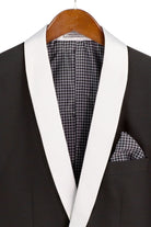 Black tuxedo with white lapels and houndstooth pattern on a hanger
