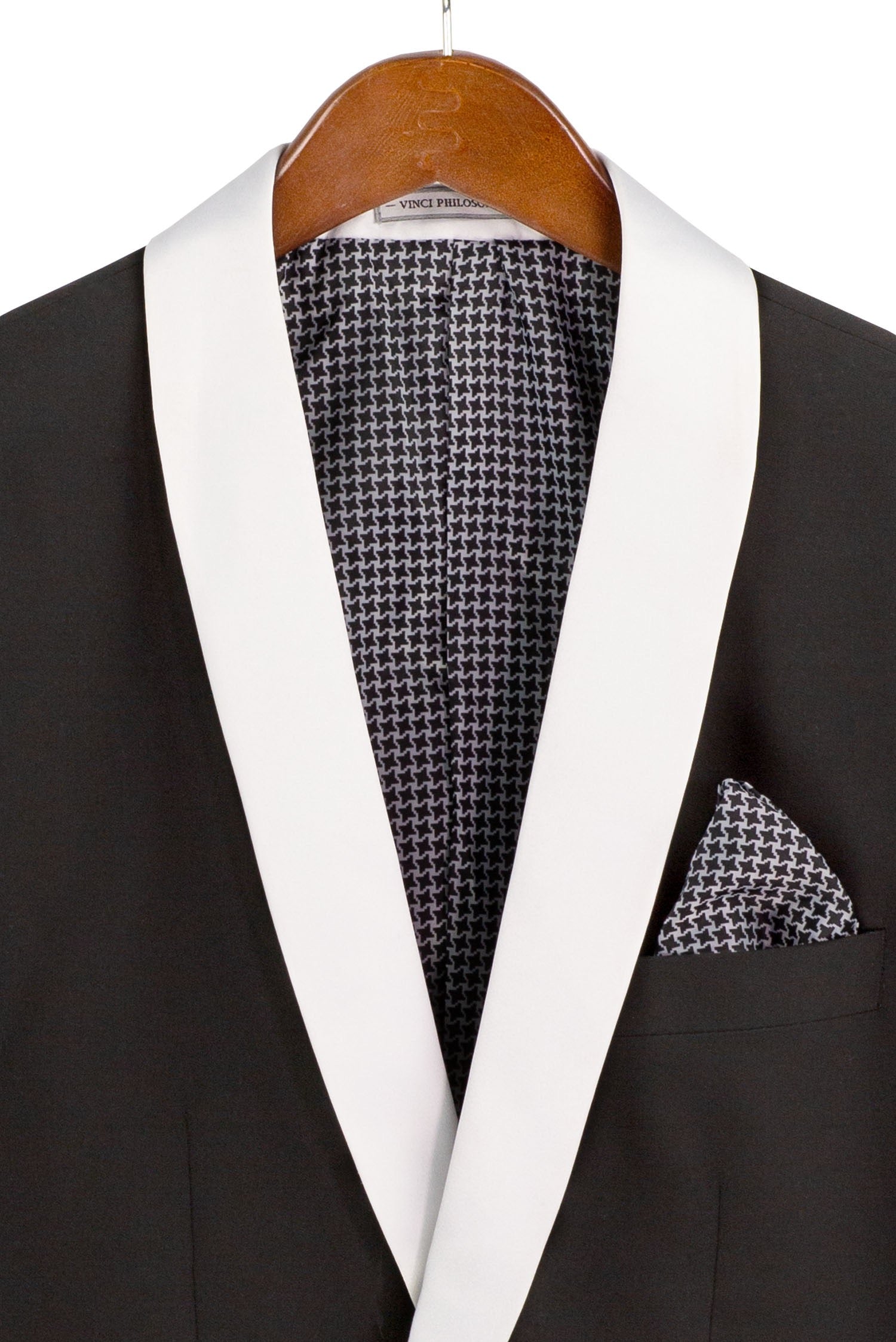 Black tuxedo with white lapels and houndstooth pattern on a hanger