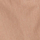 A close-up of a woven fabric texture in a warm tan or light brown color, filling the entire frame.