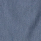 A close-up of a blue textured fabric with a fine woven pattern and soft folds.