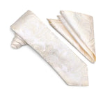 An ivory and cream paisley patterned necktie with a matching pocket square, displayed on a clean white background.