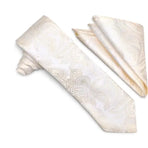 An ivory and cream paisley patterned necktie with a matching pocket square, displayed on a clean white background.