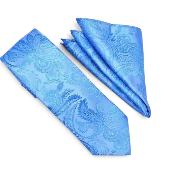 A blue necktie and matching pocket square set with a light blue paisley pattern, displayed on a clean white background.