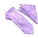 A matching men's necktie and pocket square set in light purple with a darker purple paisley pattern, displayed on a clean white background.