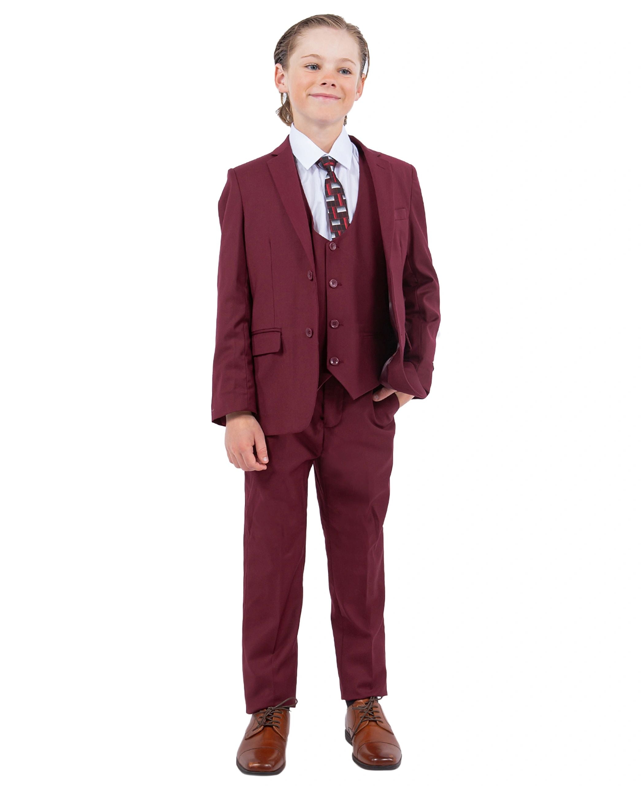 Child wearing a maroon suit with a white shirt and tie on a white background