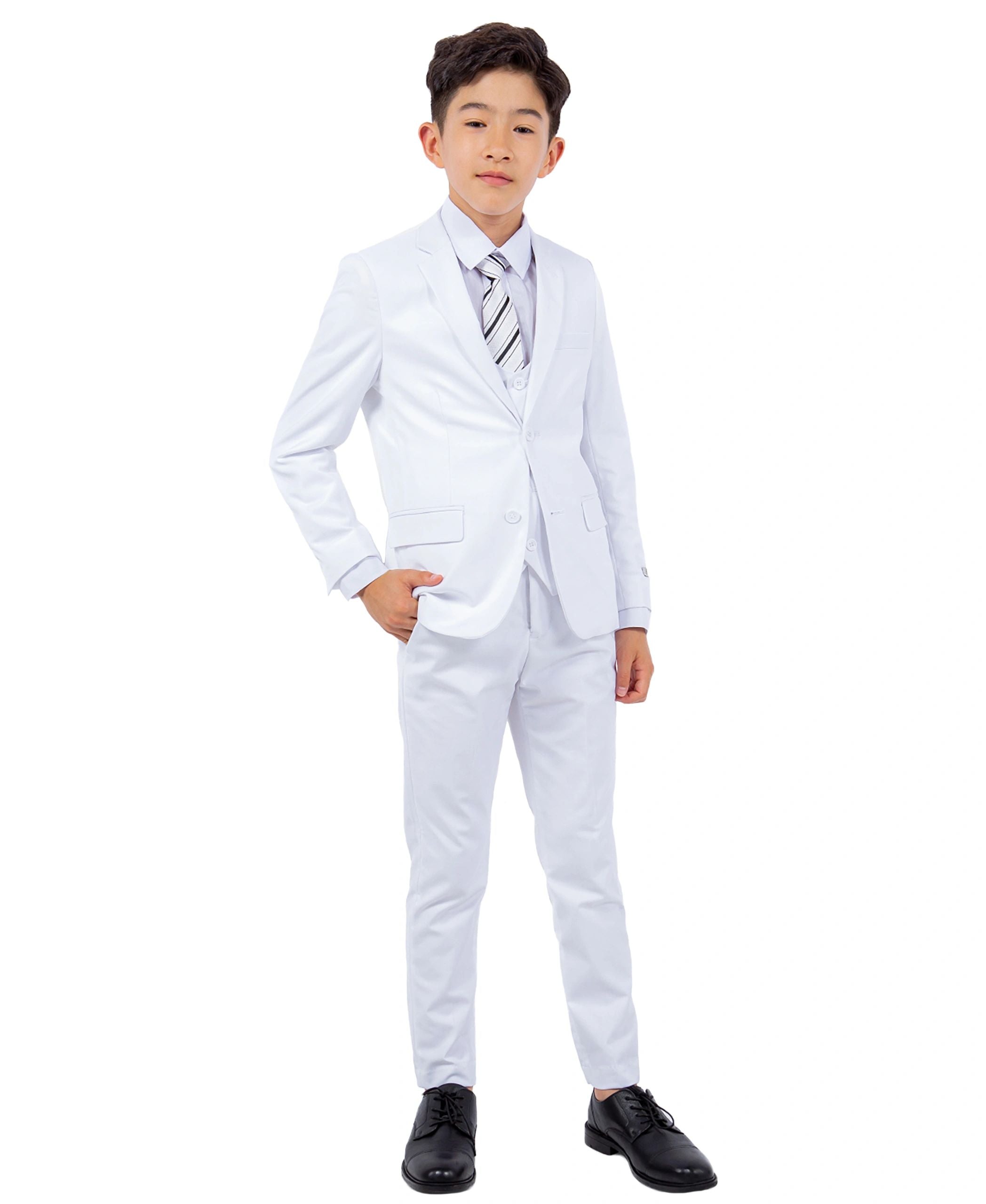 Young boy wearing a white suit with a striped tie on a white background