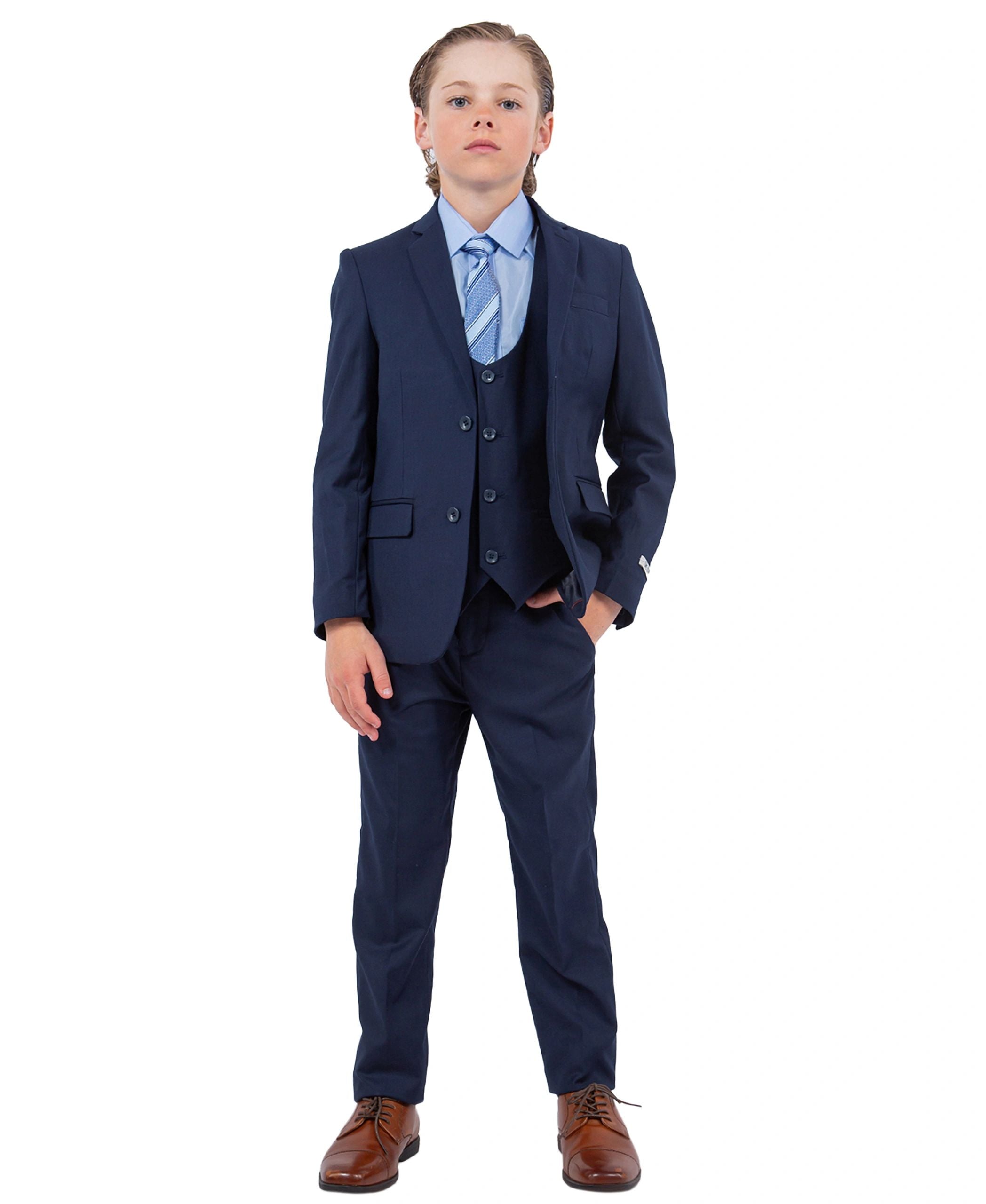 Child wearing a navy blue suit with a white shirt and brown shoes on a white background