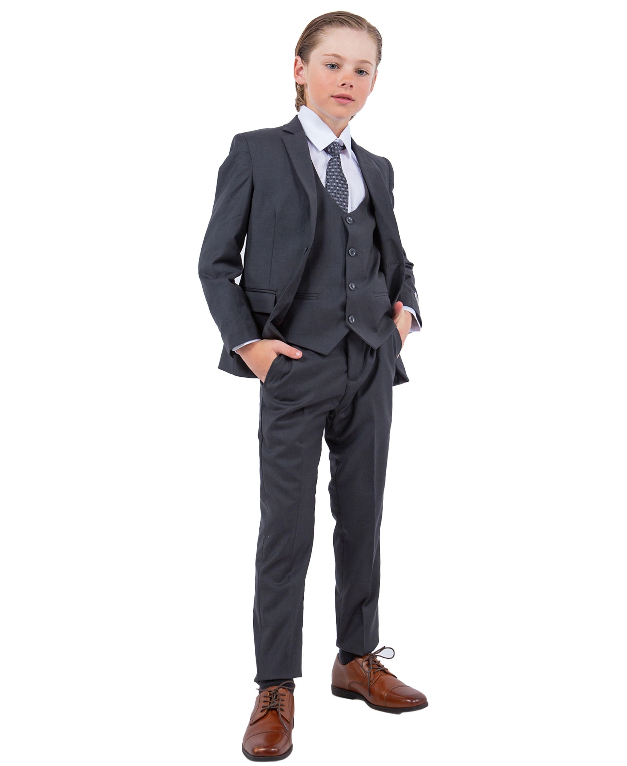 Child wearing a gray suit with a white shirt and brown shoes on a white background