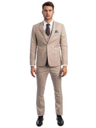 A model wearing a M & R Clothing beige skinny-fit 3-piece suit with a white shirt, polka-dot tie, and black shoes.