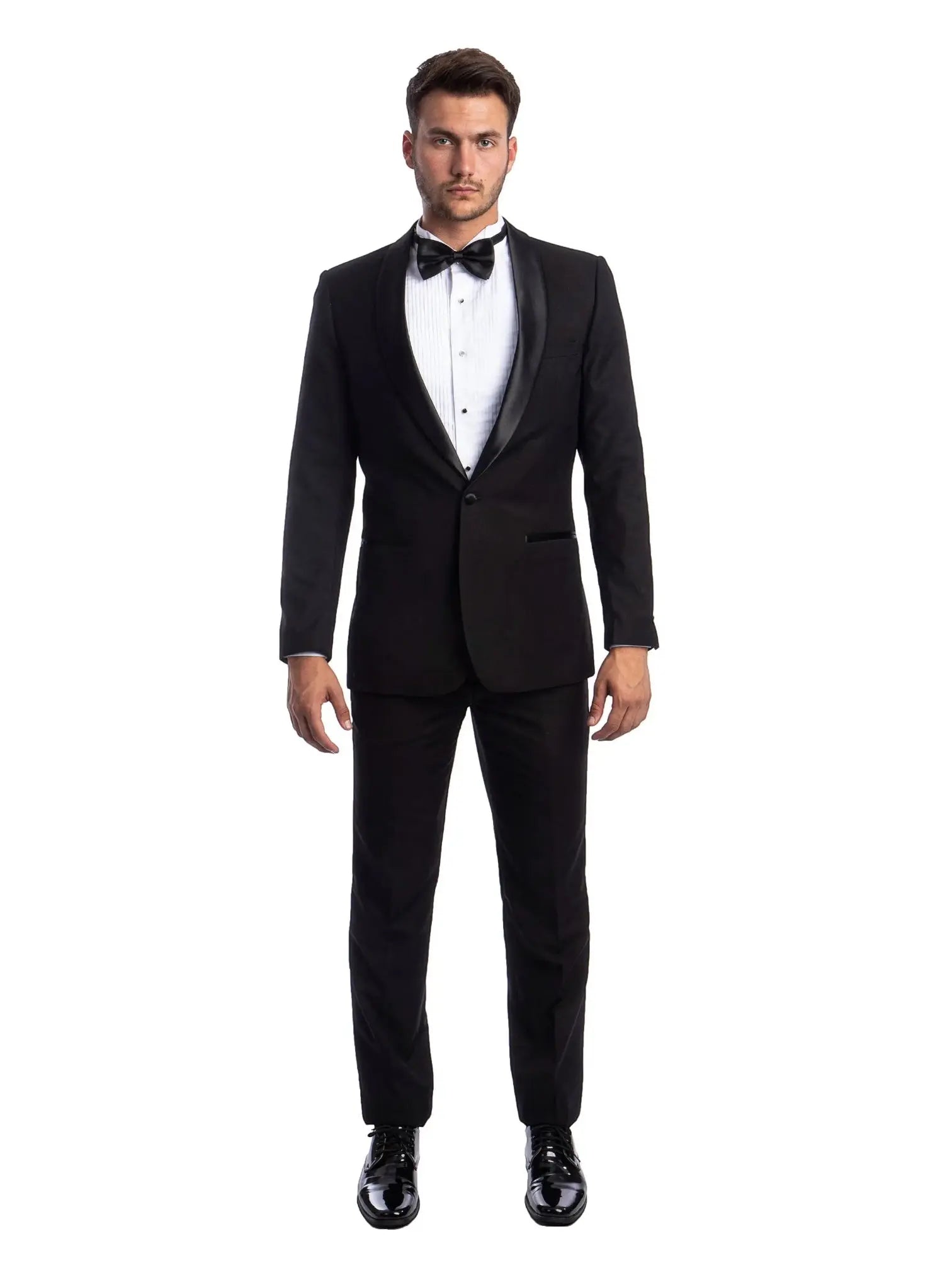 A man wearing a black M & R Clothing 2-piece tuxedo with a satin shawl collar, white shirt, and black bow tie.