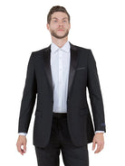 Model wearing a black M & R Clothing tuxedo jacket with a satin peak lapel and single-button closure.