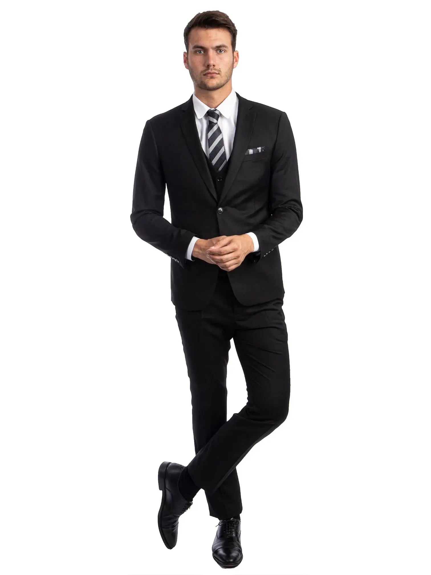 A man wearing a black M & R Clothing skinny-fit 3-piece suit with a white shirt and striped tie, full-body view.