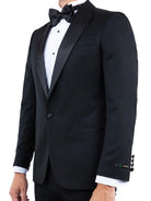M & R Clothing Zegarie black tailored-fit tuxedo jacket with satin peak lapel, white dress shirt, and bow tie.