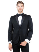 Model wearing a M & R Clothing black tailored-fit tuxedo jacket with a satin notch lapel and black bow tie.