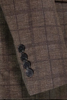 Close-up of brown plaid sleeve cuff with four buttons on an M & R Clothing slim fit suit jacket