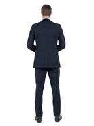 Back view of a man wearing a black M & R Clothing Bryan Michaels tuxedo jacket with a tailored fit.