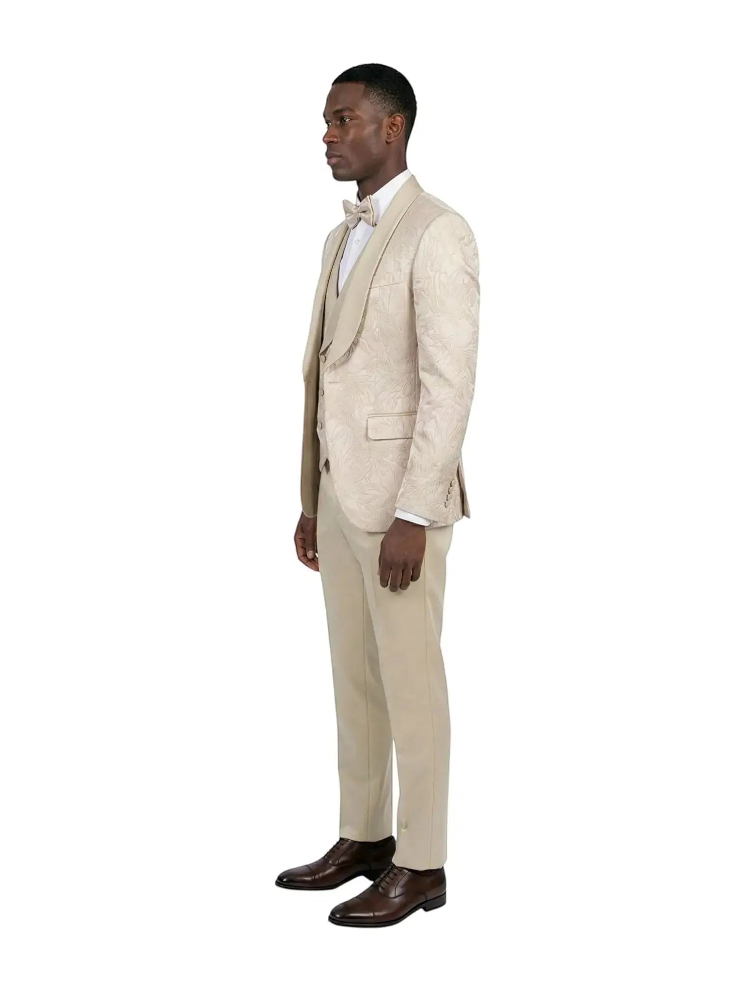 Model wearing a M & R Clothing champagne jacquard 3-piece tuxedo with a satin shawl collar and matching bowtie