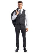 A man wearing a charcoal grey M & R Clothing skinny-fit 3-piece suit with a vest, white shirt, and patterned tie.