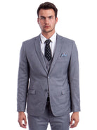 Model wearing a M & R Clothing grey skinny-fit 3-piece suit with a white shirt, black polka dot tie, and pocket square