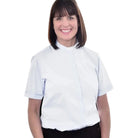 A woman wearing a light blue M & R Clothing short sleeve clergy shirt with a classic tab collar.