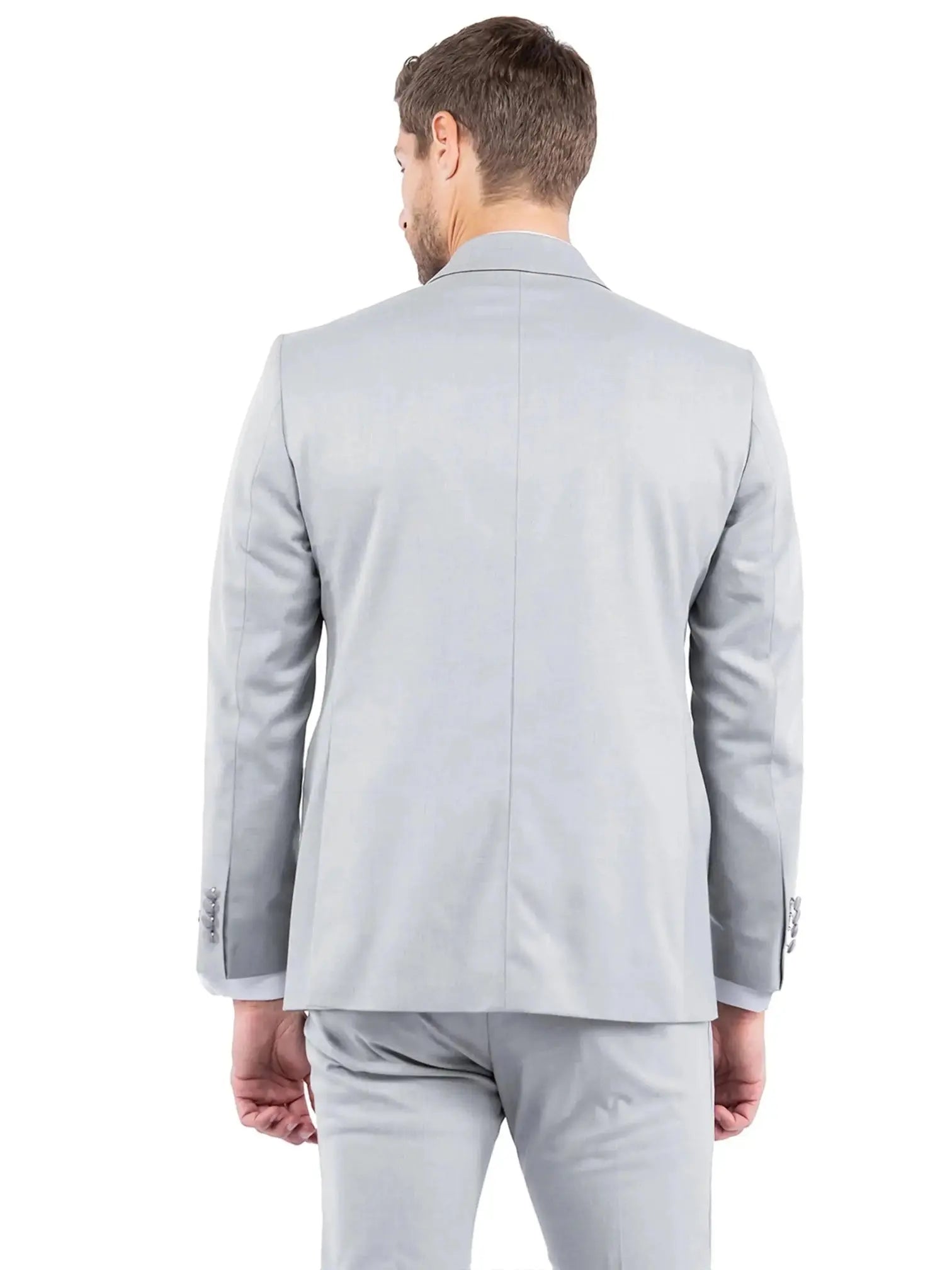 Back view of a man wearing a light grey M & R Clothing tailored-fit tuxedo jacket with a clean, structured design.