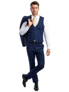 Model wearing a M & R Clothing navy blue skinny-fit 3-piece suit with a vest, white shirt, and patterned gold tie.