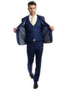 Model wearing a M & R Clothing navy blue 3-piece skinny-fit suit with a patterned lining and yellow patterned tie.