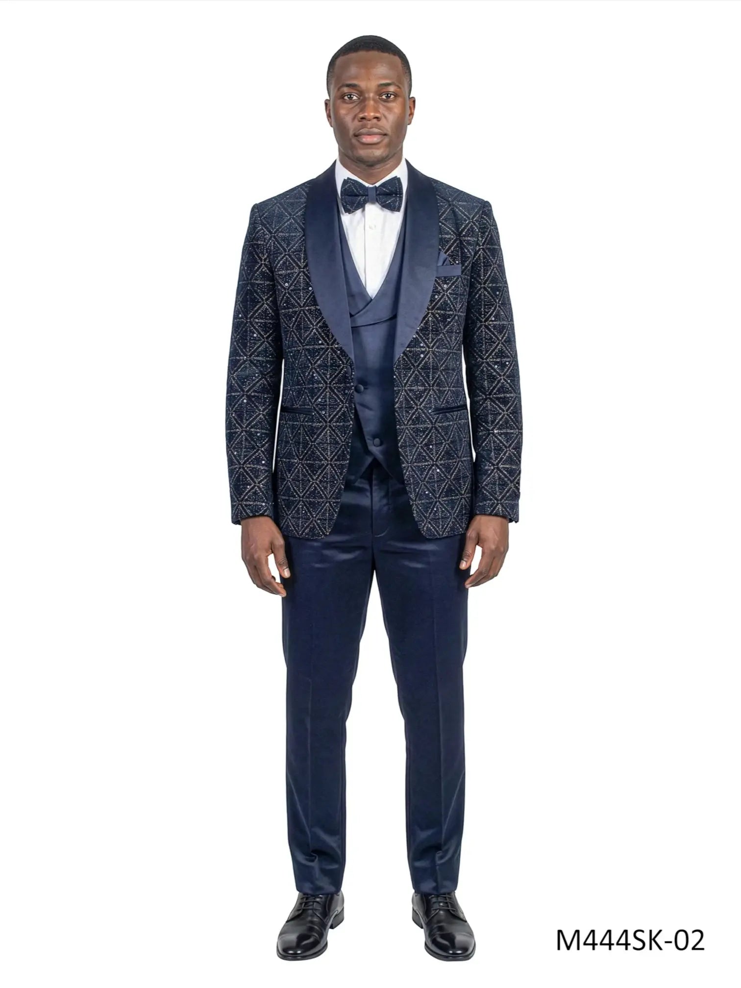 Model wearing a navy Tazio 3-piece velvet and sequin tuxedo suit set with a satin shawl collar from M & R Clothing