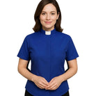 Woman wearing a royal blue M & R Clothing short sleeve clergy shirt with a classic white tab collar