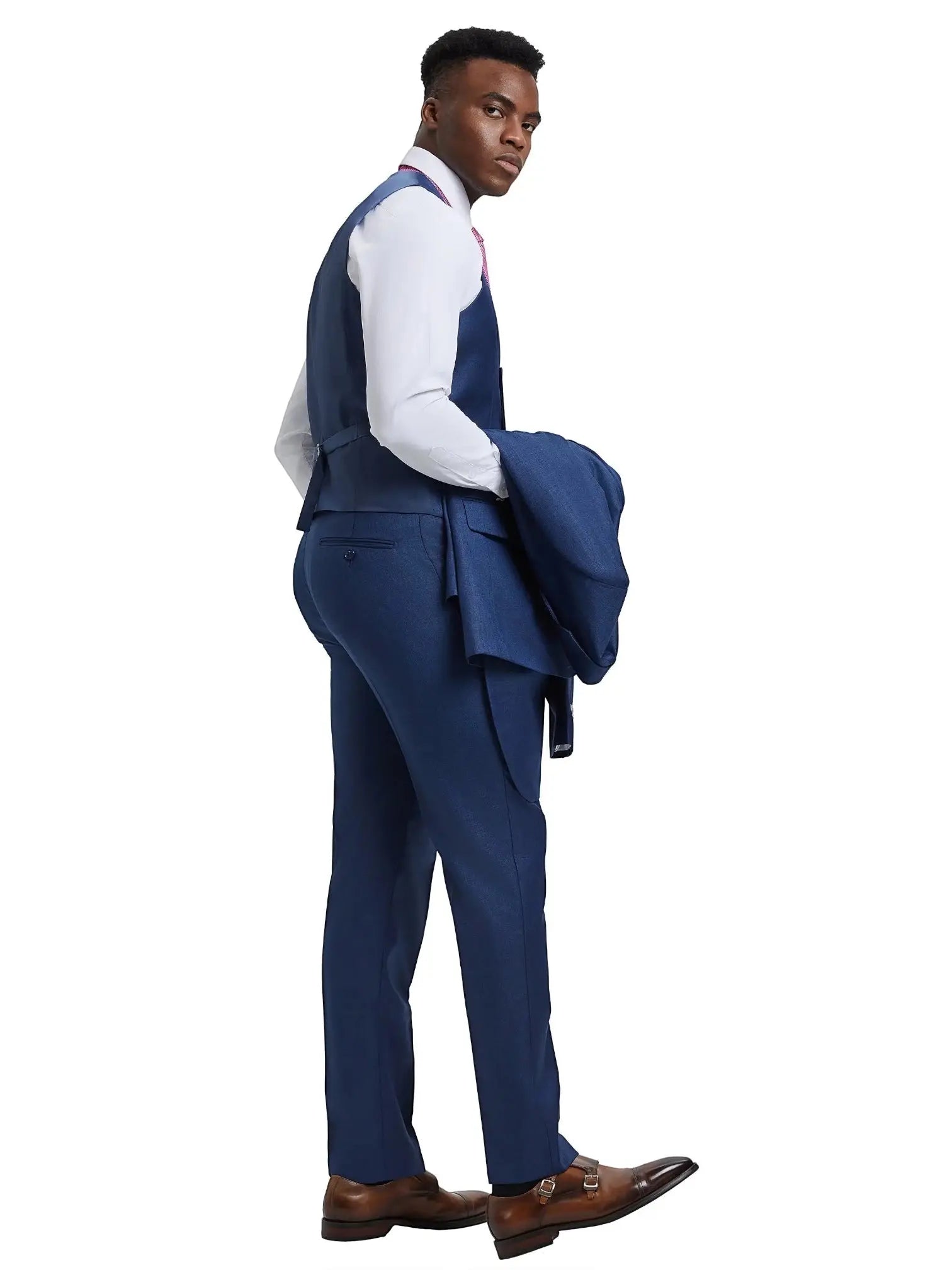 A model wearing a blue M & R Clothing Stacy Adams sharkskin 3-piece suit with a vest and jacket over his shoulder.