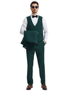 M & R Clothing Stacy Adams dark green 3-piece tuxedo set with vest, trousers, and jacket held by a model in sunglasses